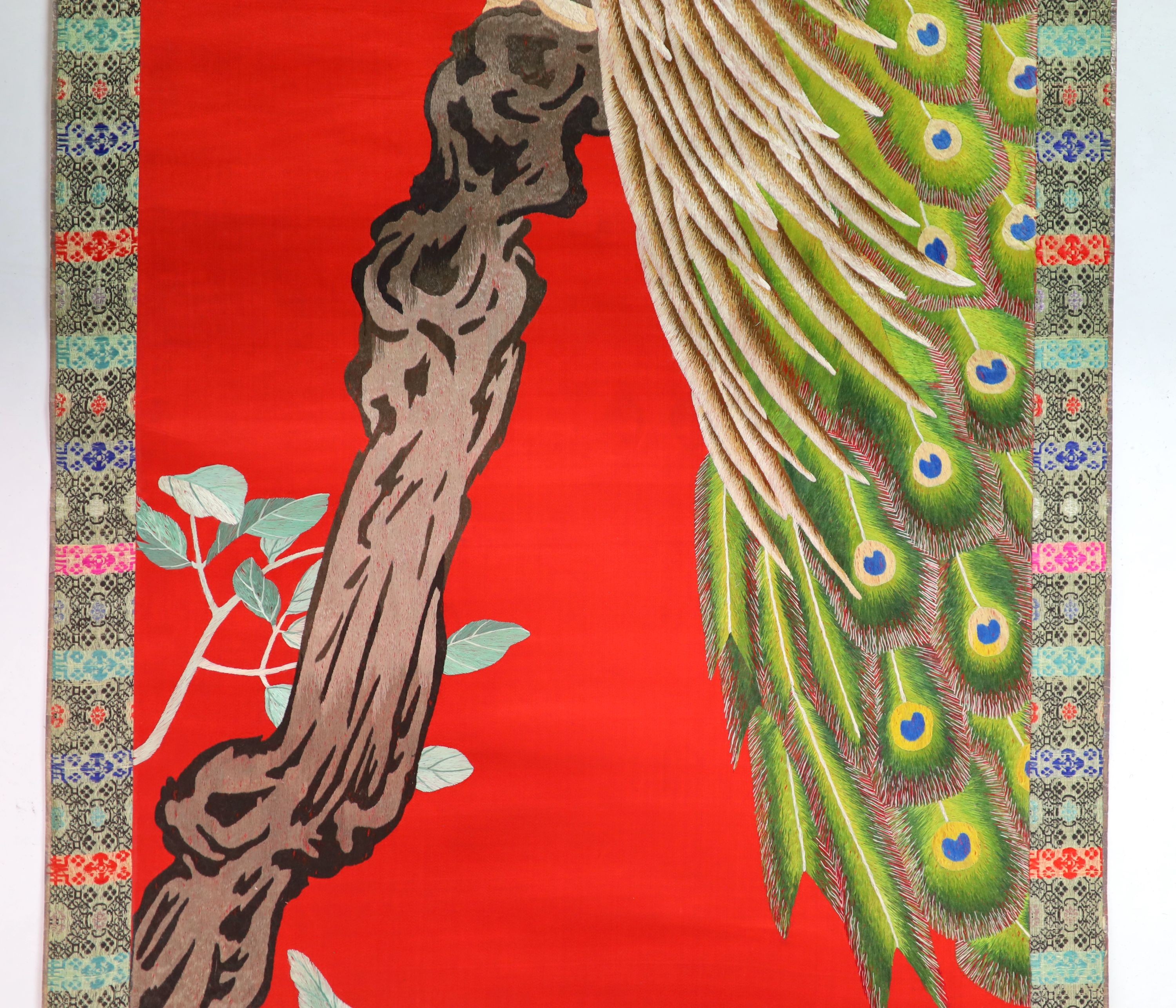A Chinese embroidered silk ‘peacock’ scroll, late 19th century, 194 x 45 cm excluding brocade borders